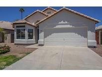 Charming single-Gathering home featuring a two-car garage and desert landscaping at 8370 W Audrey Ln, Peoria, AZ 85382