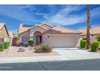 Charming single-story home with a well-manicured front yard and solar panels on the roof at 866 W Geronimo St, Chandler, AZ 85225