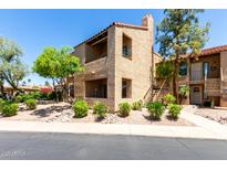Charming two-story condo with stucco exterior and well-maintained landscaping, offering a welcoming curb appeal at 8787 E Mountain View Rd # 1087, Scottsdale, AZ 85258