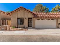Charming single-story home featuring a red tile roof, a two-car garage, and a well-maintained front yard at 927 E Charleston Ave, Phoenix, AZ 85022