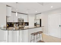 Modern kitchen with stainless steel appliances and sleek granite countertops, ready for cooking at 945 E Playa Del Norte Dr # 3009, Tempe, AZ 85288