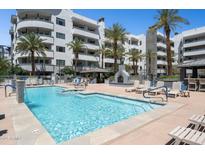 Resort-style pool area with lounge chairs and a cozy fireplace, perfect for relaxation at 945 E Playa Del Norte Dr # 3009, Tempe, AZ 85288