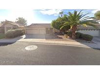 Charming single-story home featuring a three-car garage and mature landscaping at 1038 S Palomino Creek Dr, Gilbert, AZ 85296