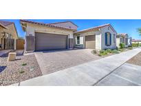 Charming single Gathering home featuring an attached two car garage and desert landscaping at 10715 E Thornton Ave, Mesa, AZ 85212