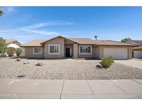 Charming single-story home featuring a tile roof, desert landscaping, and an attached two-car garage at 1231 E Sunburst Ln, Tempe, AZ 85284