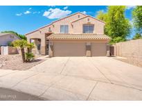 Charming two-story home with a three-car garage and a well-maintained, desert landscaped front yard at 1254 W Browning Way, Chandler, AZ 85286