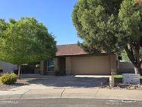 Inviting single-story home featuring a neutral color palette, a tile roof, mature trees, and a two-car garage at 1309 W Calle Del Norte --, Chandler, AZ 85224