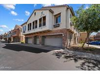 Charming townhouse featuring a blend of stucco and stone accents, plus multiple garages at 1350 S Greenfield Rd # 2133, Mesa, AZ 85206
