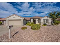 Charming single-story home with desert landscaping and a two-car garage at 15936 W Kino Dr, Surprise, AZ 85374