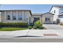 Charming single-story home featuring manicured landscaping, a welcoming entrance, and modern architectural details at 17183 W San Marcos St, Surprise, AZ 85388