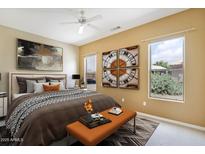 Bright bedroom with stylish decor, comfortable bed, and a relaxing ambiance filled with natural light from the windows at 19803 N Desert Song Ct, Surprise, AZ 85374