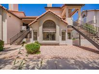 Charming condo exterior with large windows, terra cotta roof, and a desert-landscaped front yard at 19820 N 13Th Ave # 175, Phoenix, AZ 85027