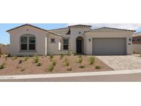Stunning home exterior featuring a paver driveway and low-maintenance desert landscaping at 21541 W Mariposa St, Buckeye, AZ 85396