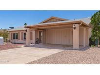 Single story home with a covered carport and desert landscaping at 2423 E Dahlia Dr, Phoenix, AZ 85032