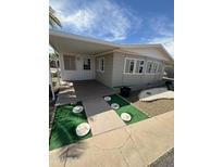 Charming single-story home features a covered entrance with decorative stepping stones and landscaped yard at 3104 E Broadway Rd # 348, Mesa, AZ 85203