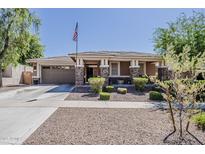 Charming single-story home with neutral colors, front yard, and attached two car garage at 3173 N Clanton St, Buckeye, AZ 85396