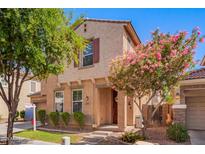 Charming two-story home with a well-maintained lawn, mature trees, and desert landscaping at 4043 E Carla Vista Dr, Gilbert, AZ 85295