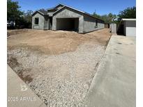 Unfinished exterior with a garage and a modern architectural design at 415 S Robert S Rd, Tempe, AZ 85281