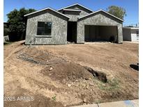 Unfinished exterior view of a single-Gathering home with a two-car garage at 415 S Robert S Rd, Tempe, AZ 85281
