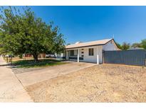 Charming single-story home featuring a spacious front yard and inviting curb appeal under a bright blue sky at 8132 W Pierson St, Phoenix, AZ 85033