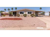 Inviting single-story home featuring a charming front yard and covered parking at 8730 E Dewan Ave, Mesa, AZ 85208