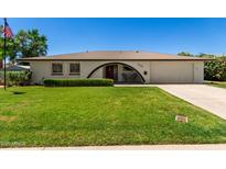 Charming single-story home featuring a lush green lawn and well-maintained landscaping at 9436 N 41St Dr, Phoenix, AZ 85051