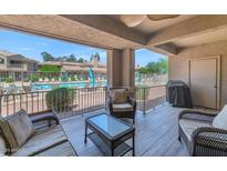 Relaxing outdoor patio with comfortable seating, a view of the pool, and a peaceful ambiance at 955 E Knox Rd # 137, Chandler, AZ 85225