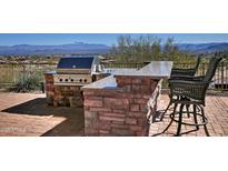 Outdoor kitchen with granite countertop, grill, and bar seating with mountain view at 10841 N Mountain Vista Mtn, Fountain Hills, AZ 85268
