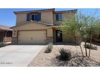 Charming two-story home featuring desert landscaping, a two-car garage, and a well-manicured lawn at 1091 W West Virginia Ave, Florence, AZ 85132