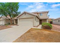 Charming two-story home featuring a neutral color palette, a two car garage, and low-maintenance landscaping at 11710 W Paradise Dr, El Mirage, AZ 85335