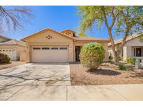 Charming single-story home featuring a two-car garage and low maintenance desert landscaping at 12355 W Hadley St, Avondale, AZ 85323
