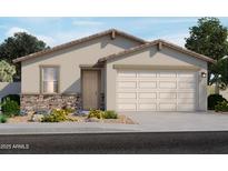 Charming single-story home featuring a two-car garage and stone accents, surrounded by lush landscaping at 17303 W Eva St, Waddell, AZ 85355