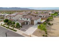 Stunning aerial view of home showcasing desert landscaping, tile roof, and multi-car garage in a beautiful community at 19026 W Becker Ln, Surprise, AZ 85388