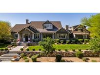 Stunning two-story home with mature landscaping, stone accents, and a classic architectural design at 19296 N 98Th Pl, Scottsdale, AZ 85255