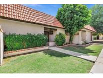 Charming single-story home features a well-maintained lawn, desert landscaping, and a vibrant, tiled roof at 195 N Cottonwood St # 26, Chandler, AZ 85225