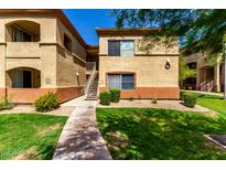 Well-maintained apartment building exterior with manicured lawn and inviting walkway on a sunny day at 2134 E Broadway Rd # 1062, Tempe, AZ 85282