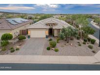 Charming single-story home with well-manicured desert landscaping and a neutral color palette at 31207 N 124Th Dr, Peoria, AZ 85383