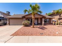 Charming single-Gathering home featuring desert landscaping, a mature palm tree, and an attached two-car garage at 4110 W Villa Linda Dr, Glendale, AZ 85310