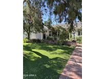 Charming home with a lush green lawn, brick walkway, and beautiful landscaping, creating a welcoming and picturesque exterior at 5118 E Mulberry Dr, Phoenix, AZ 85018