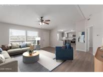 Bright living room with modern furniture, ceiling fan, and large windows at 52680 W Meadow Green Rd, Maricopa, AZ 85139