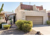 Charming home featuring a two-car garage, complemented by well-maintained desert landscaping in the front yard at 5637 N 78Th Way, Scottsdale, AZ 85250