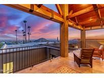 Wide covered patio with open architecture to appreciate Arizona sunset views from the comfortable seating at 8752 E Range Rider Trl, Mesa, AZ 85207