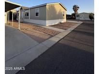 View of a light tan single-story home, with easy-to-maintain gravel landscaping and concrete walkway at 8832 E Pueblo Ave # 20, Mesa, AZ 85208
