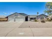 Charming single-story home with a well-maintained front yard and spacious three-car garage at 8942 W Peck Dr, Glendale, AZ 85305