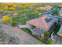 Spacious backyard with a covered patio, outdoor kitchen, fire pit and mountain views at 13236 W Montansoro Ln, Peoria, AZ 85383