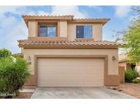 Two-story home with a neutral color scheme, two-car garage, and well maintained landscaping at 13443 W Crocus Dr, Surprise, AZ 85379