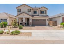 Charming two-story home featuring desert landscaping and a welcoming front porch at 14435 W El Cortez Pl, Surprise, AZ 85387