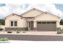 Charming single-story home featuring a two-car garage, neutral stucco, and a well-manicured front yard at 15833 W Bronco Trl, Surprise, AZ 85387