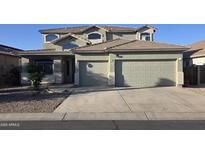 Inviting two-story home featuring a two-car garage and a well-maintained front yard at 18174 E Via Jardin --, Gold Canyon, AZ 85118