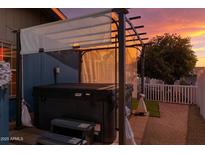 A hot tub area with a privacy screen and sunset views creates a relaxing retreat at 201 S Greenfield Rd # 173, Mesa, AZ 85206